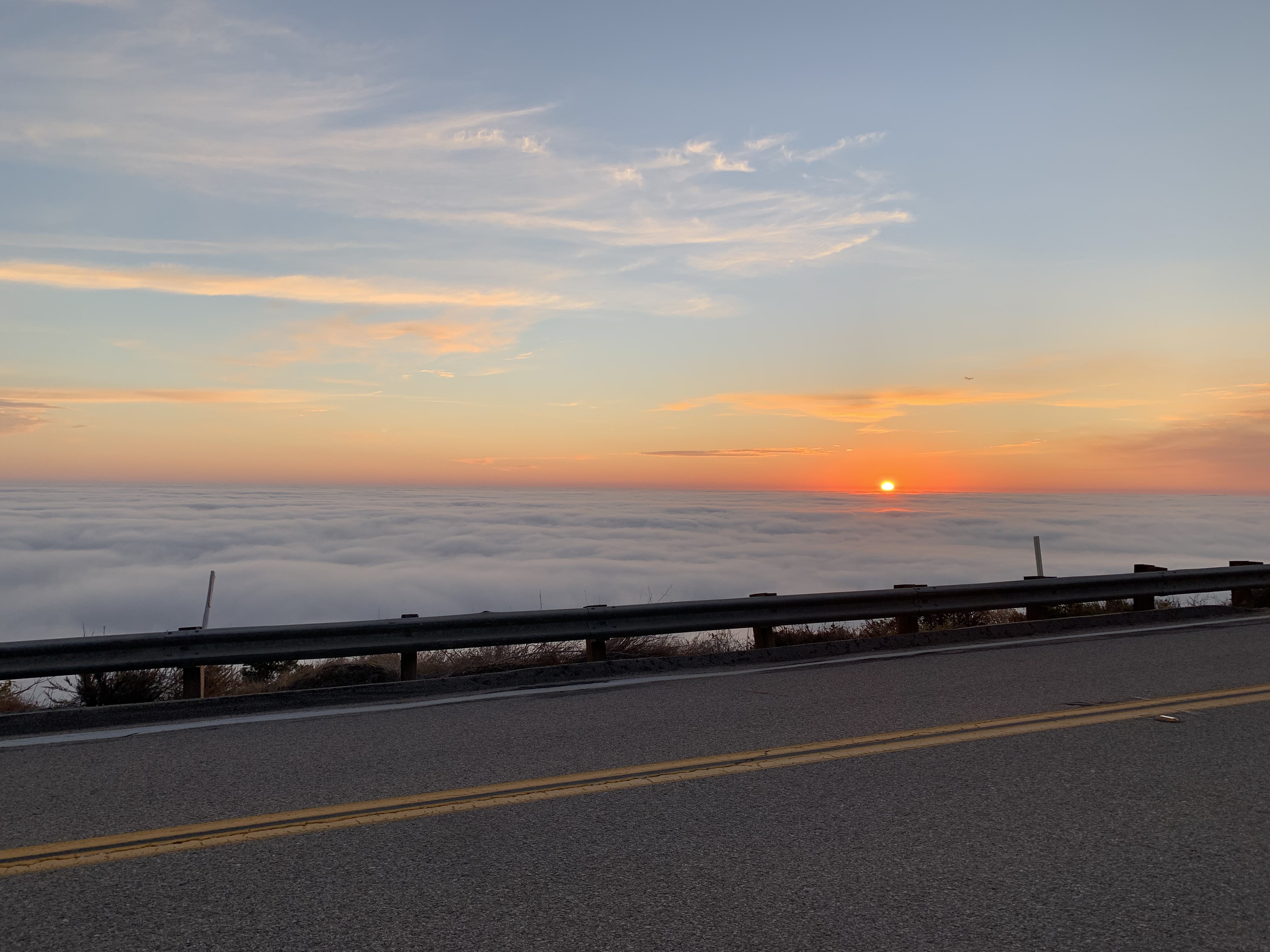 Picture of the sun about to set over some clouds